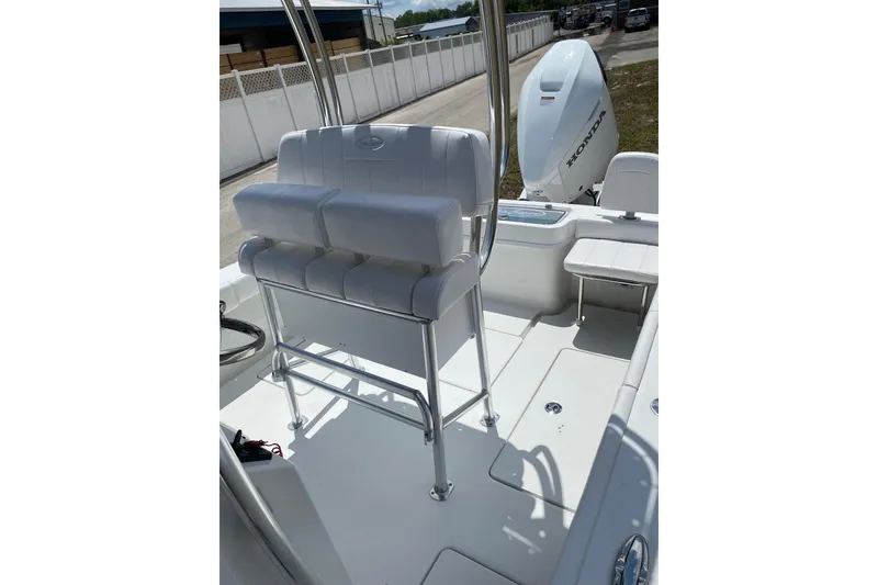 Slide: The Image of 2026 Pair Customs 21 Center Console MV boat interior with seating and Honda engine. - 9