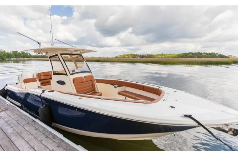 The Image of Manufacturer Provided Image: 2021 Scout 277 LXF boat docked on a calm lake. - 0