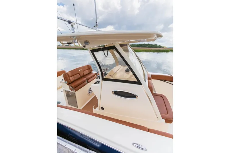 Slide: The Image of Manufacturer Provided Image: 2021 Scout 277 LXF boat interior with brown seating and helm station. - 12