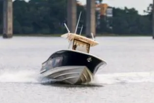 Slide: The Image of Manufacturer Provided Image: 2021 Scout 277 LXF boat cruising on a river. - 3