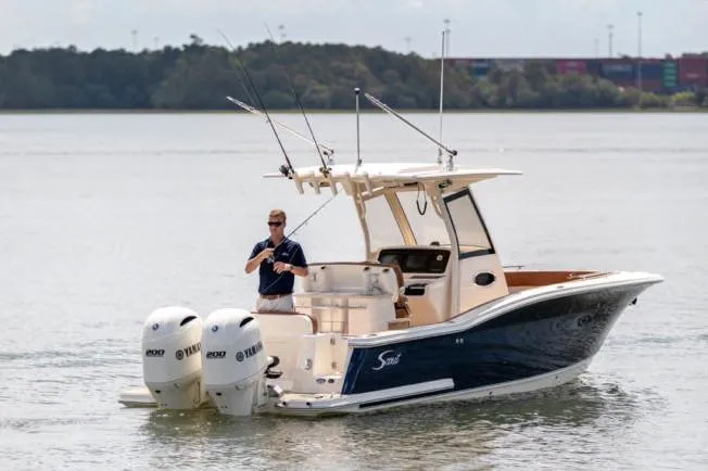 Slide: The Image of Manufacturer Provided Image: 2021 Scout 277 LXF boat with dual Yamaha engines on calm water. - 6