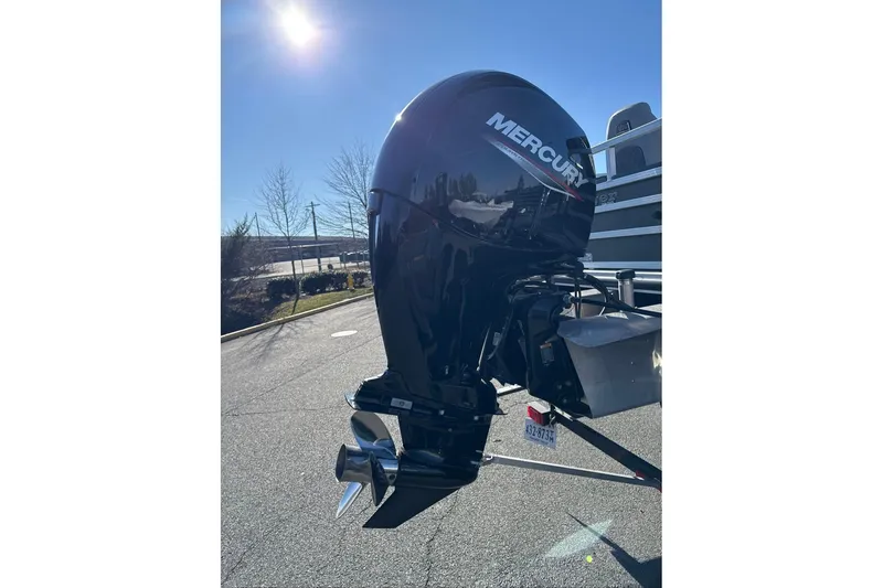 Slide: The Image of 2024 Ranger Reata 220F boat with Mercury outboard motor in sunlight. - 2
