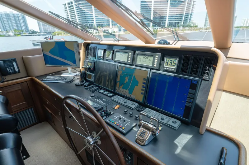 Slide: The Image of Pilothouse of 2007 Pacific Mariner yacht with advanced navigation equipment and steering wheel. - 12