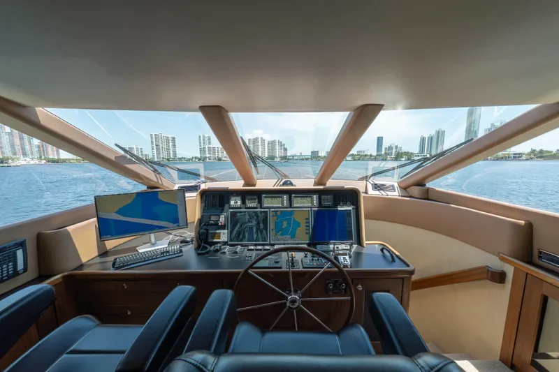 Slide: The Image of Luxurious 2007 Pacific Mariner Pilothouse yacht interior with navigation equipment and city skyline view. - 13
