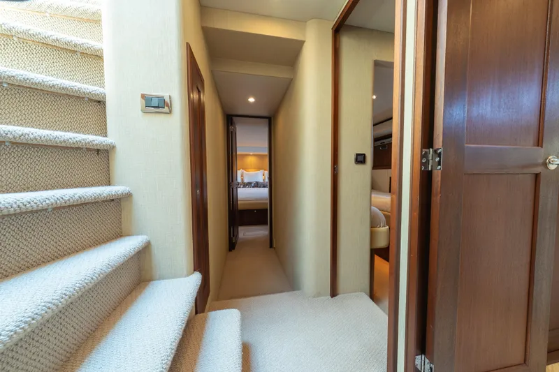 Slide: The Image of Interior hallway of 2007 Pacific Mariner Pilothouse yacht with carpeted stairs and wooden doors. - 15