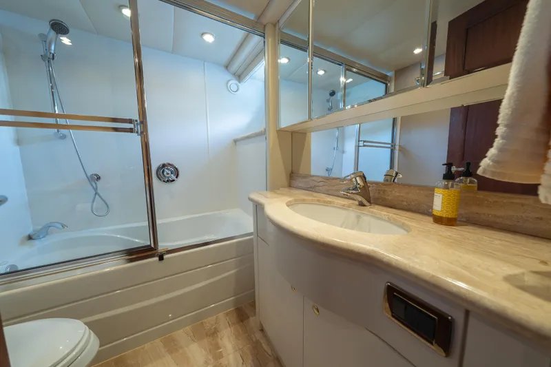Slide: The Image of Luxurious bathroom in a 2007 Pacific Mariner Pilothouse yacht, featuring elegant fixtures and ample lighting. - 19