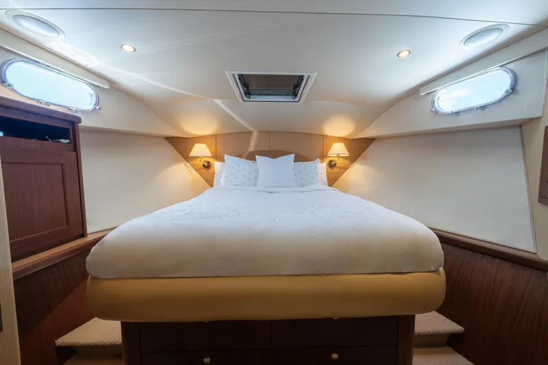 Slide: The Image of Luxurious bedroom interior of 2007 Pacific Mariner Pilothouse yacht with cozy bedding and ambient lighting. - 20
