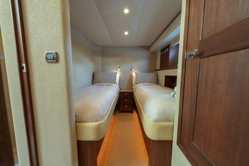 Slide: The Image of 2007 Pacific Mariner Pilothouse cabin with twin beds and wooden interior. - 24