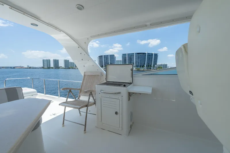 Slide: The Image of 2007 Pacific Mariner Pilothouse yacht deck with seating, grill, and waterfront view. - 29