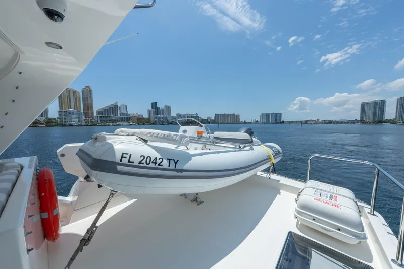 Slide: The Image of 2007 Pacific Mariner Pilothouse yacht with inflatable boat, city skyline in background. - 33