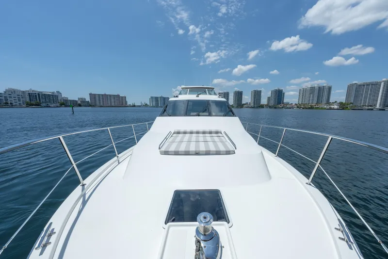 Slide: The Image of 2007 Pacific Mariner Pilothouse yacht cruising near city skyline under blue sky. - 36