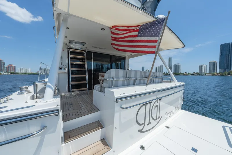 Slide: The Image of 2007 Pacific Mariner Pilothouse yacht with American flag, docked near city skyline. - 42