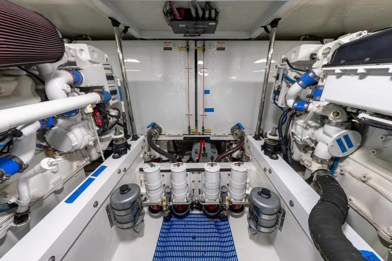 Slide: The Image of Engine room of a 2007 Pacific Mariner Pilothouse yacht, showcasing mechanical components and systems. - 48