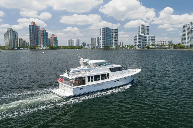 Slide: The Image of 2007 Pacific Mariner Pilothouse yacht cruising near city skyline under blue skies. - 53