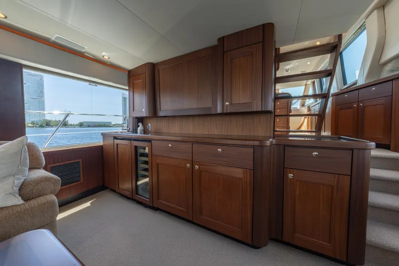 Slide: The Image of Luxurious 2007 Pacific Mariner Pilothouse interior with elegant wood cabinetry and waterfront view. - 6