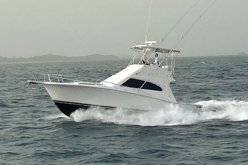 The Image of 2004 Luhrs 38 Convertible Yacht cruising on open sea. - 0