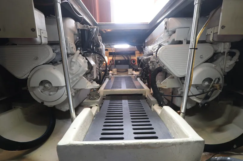 Slide: The Image of Engine room of 2004 Luhrs 38 Convertible boat, showcasing dual engines and mechanical components. - 12