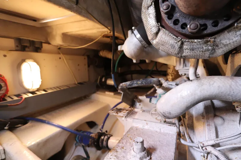 Slide: The Image of Engine room of 2004 Luhrs 38 Convertible boat with visible pipes and machinery. - 14