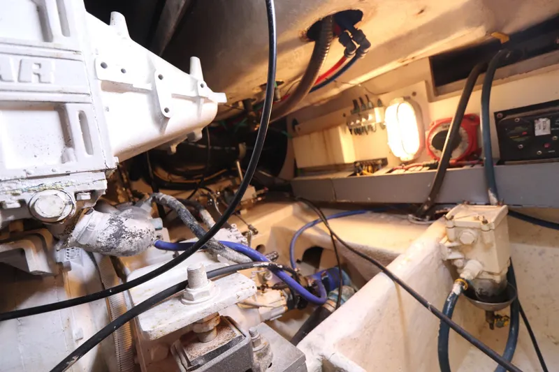 Slide: The Image of Engine room of 2004 Luhrs 38 Convertible boat, showcasing mechanical components and wiring. - 15