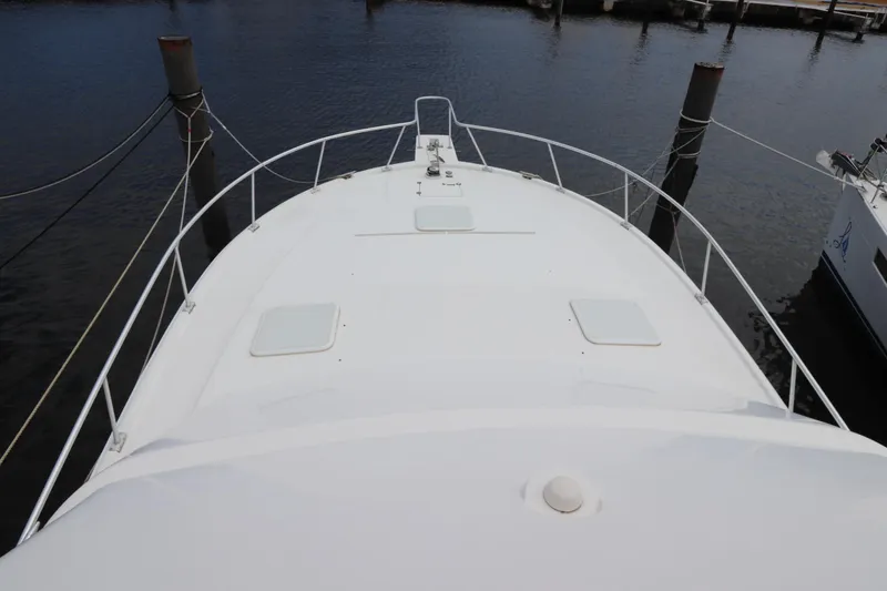 Slide: The Image of 2004 Luhrs 38 Convertible yacht bow view at marina dock. - 19