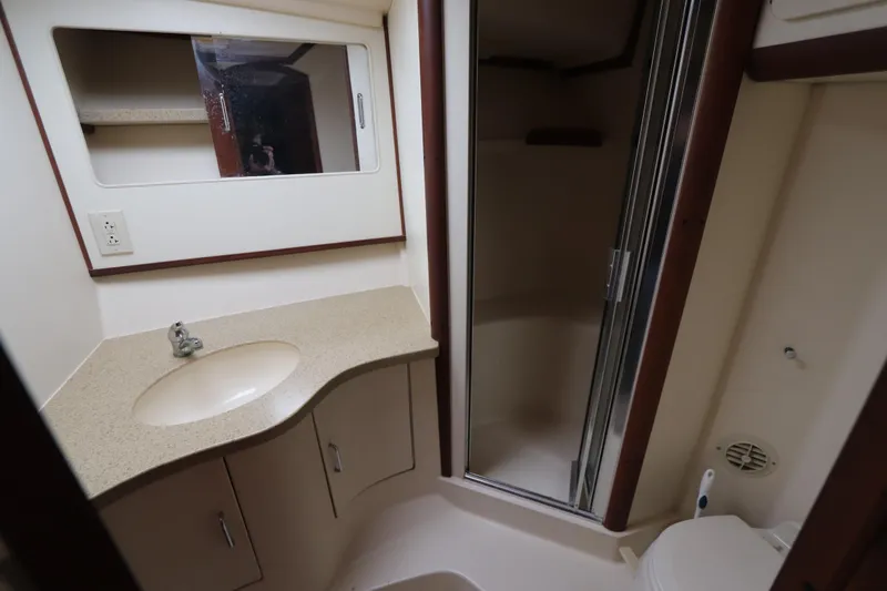 Slide: The Image of 2004 Luhrs 38 Convertible yacht bathroom with sink, mirror, and shower. - 7