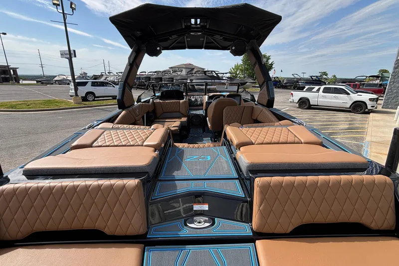 Slide: The Image of 2026 Tigé Z3 boat with luxurious tan seating and sleek design in a parking lot. - 10