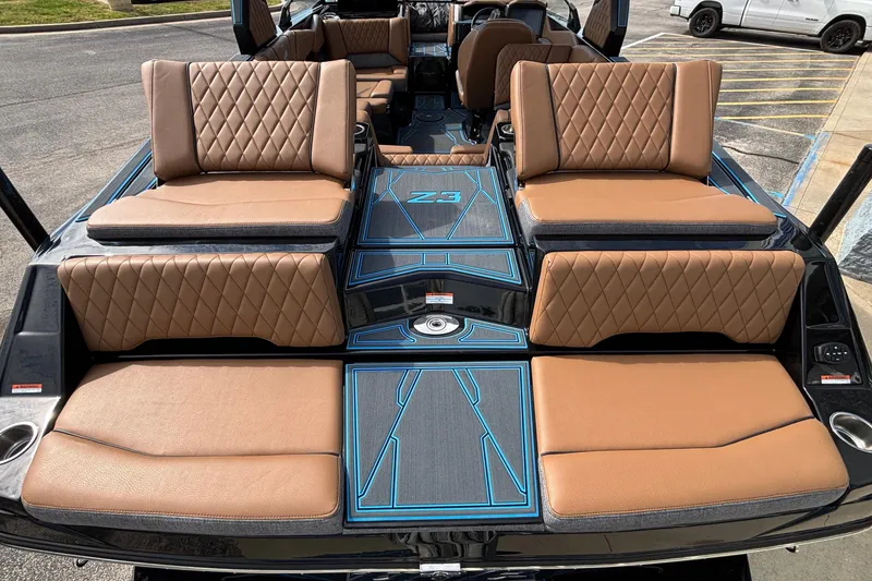 Slide: The Image of 2026 Tigé Z3 boat interior with luxurious tan quilted seating and sleek design. - 11
