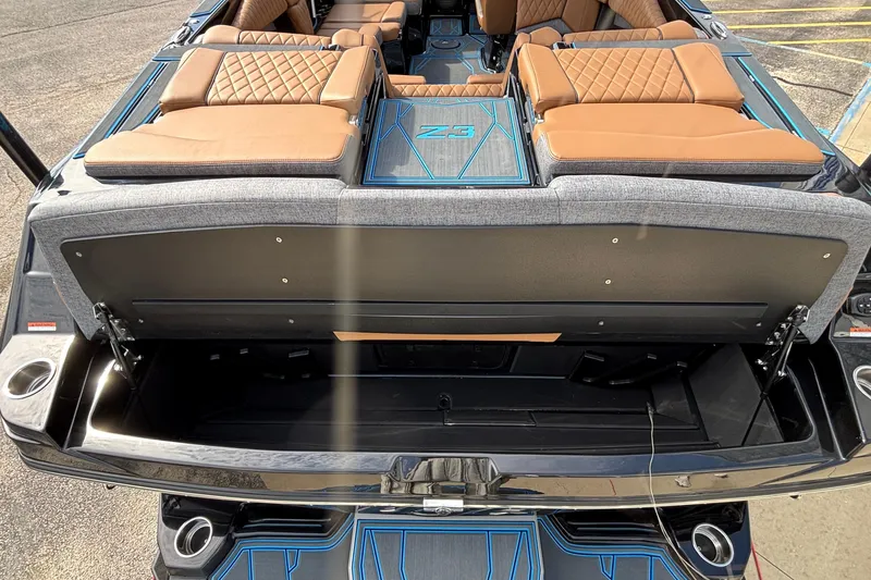 Slide: The Image of 2026 Tigé Z3 boat interior with open storage compartment and tan seating. - 12