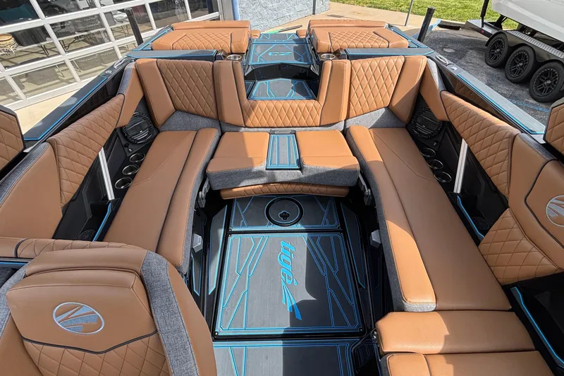 Slide: The Image of Luxurious interior of 2026 Tigé Z3 boat with tan leather seating and blue accents. - 14