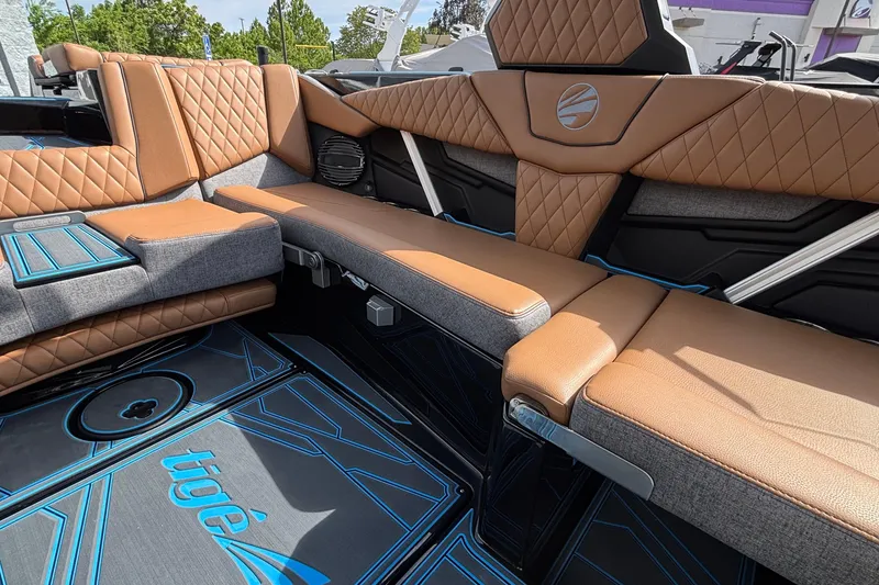 Slide: The Image of 2026 Tigé Z3 boat interior with luxurious tan and gray seating, featuring diamond stitching. - 17
