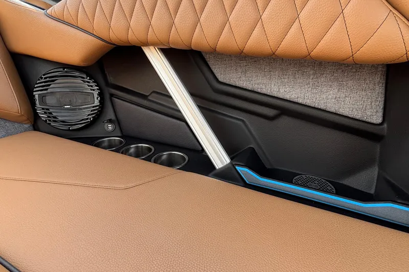 Slide: The Image of 2026 Tigé Z3 interior with brown leather seats, speaker, and cup holders. - 19