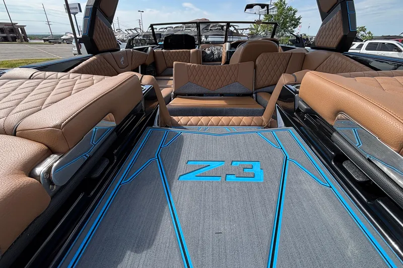 Slide: The Image of 2026 Tigé Z3 boat interior with luxurious brown seating and blue-accented flooring. - 26