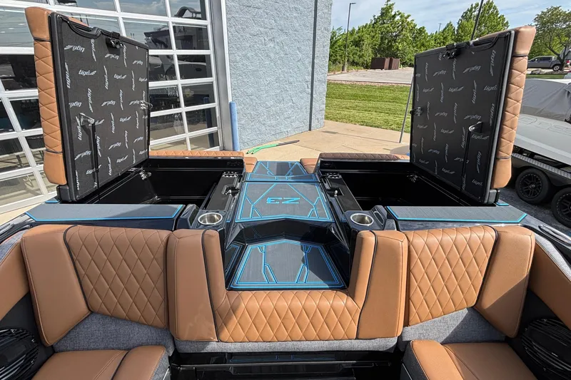 Slide: The Image of 2026 Tigé Z3 boat interior with tan quilted seats and open storage compartments. - 27
