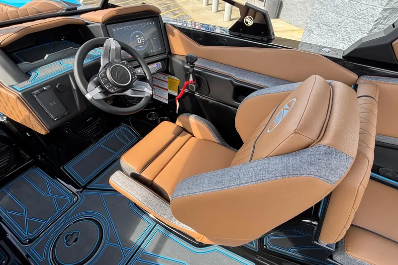 Slide: The Image of 2026 Tigé Z3 boat interior with modern dashboard, steering wheel, and tan leather seating. - 31