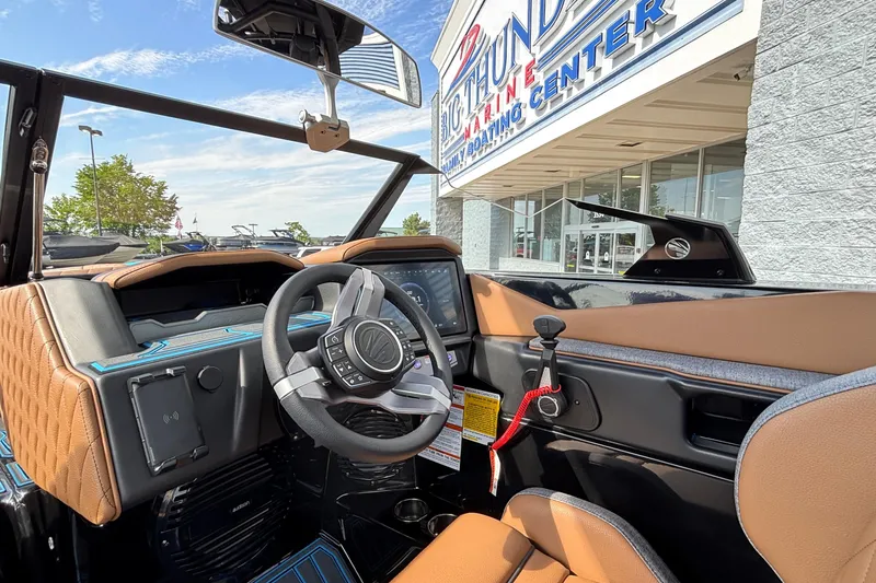 Slide: The Image of Interior view of 2026 Tigé Z3 boat at dealership, showcasing steering wheel and dashboard. - 32