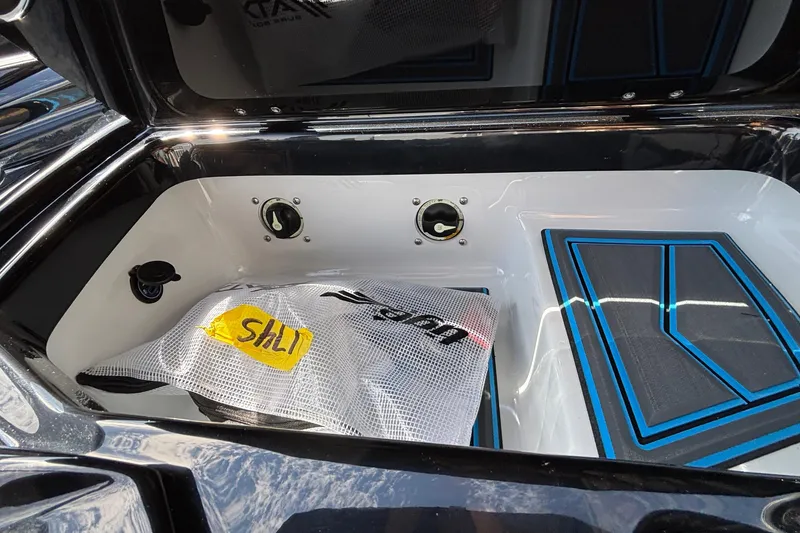 Slide: The Image of 2026 Tigé Z3 boat storage compartment with gear and blue accents. - 37