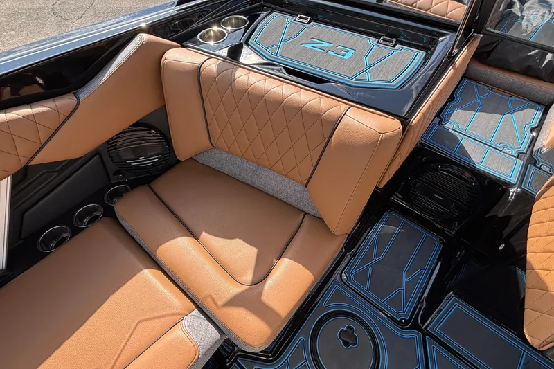 Slide: The Image of 2026 Tigé Z3 boat interior with tan leather seats and blue-accented flooring. - 39
