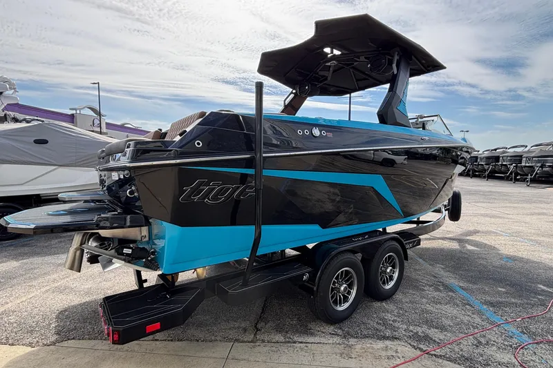 Slide: The Image of 2026 Tigé Z3 boat with sleek black and blue design on a trailer. - 4