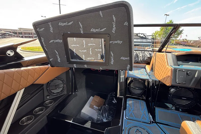 Slide: The Image of 2026 Tigé Z3 boat interior with brown leather seats and modern audio system. - 43