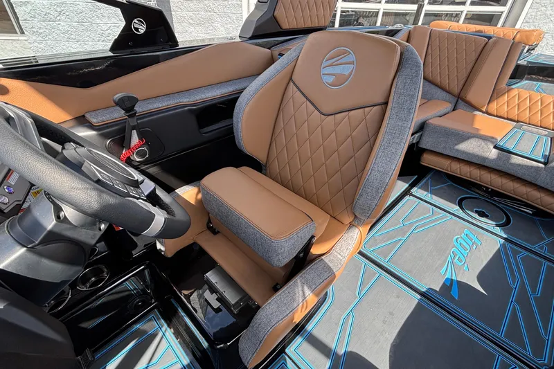 Slide: The Image of 2026 Tigé Z3 boat interior with tan and gray seating, modern steering, and stylish flooring. - 44
