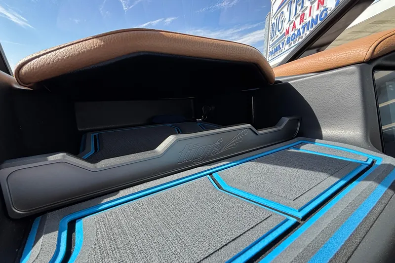 Slide: The Image of 2026 Tigé Z3 interior dashboard with blue accents and storage compartment. - 45