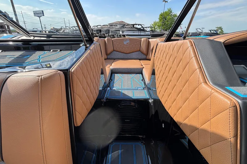 Slide: The Image of 2026 Tigé Z3 boat interior with tan quilted seats and blue accents. - 46