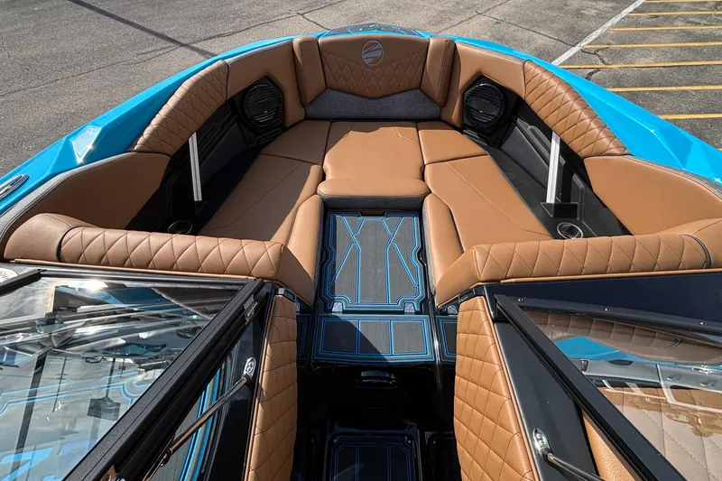 Slide: The Image of 2026 Tigé Z3 boat interior with brown quilted seats and blue accents. - 47