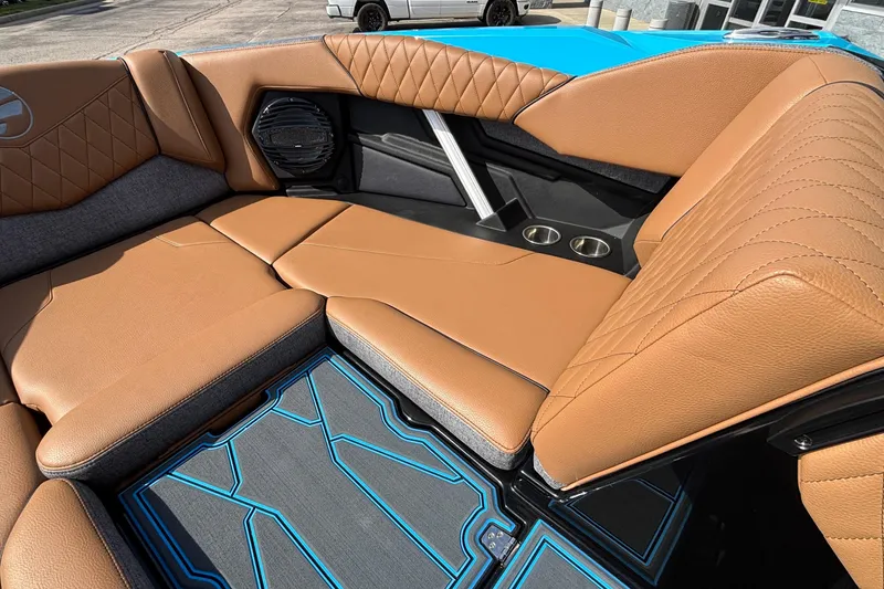 Slide: The Image of 2026 Tigé Z3 boat interior with tan leather seats, cup holders, and stylish flooring. - 49