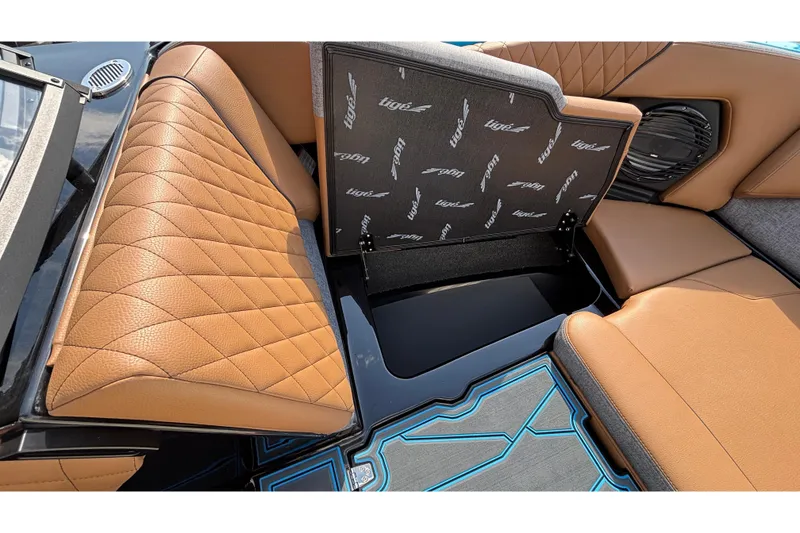 Slide: The Image of 2026 Tigé Z3 boat interior with tan quilted seats and storage compartment. - 52