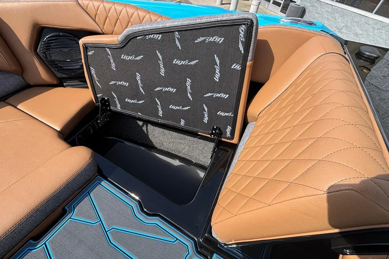 Slide: The Image of 2026 Tigé Z3 boat interior with tan quilted seats and storage compartment. - 53