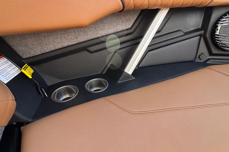 Slide: The Image of Interior of 2026 Tigé Z3 boat featuring brown leather seats and dual cup holders. - 54