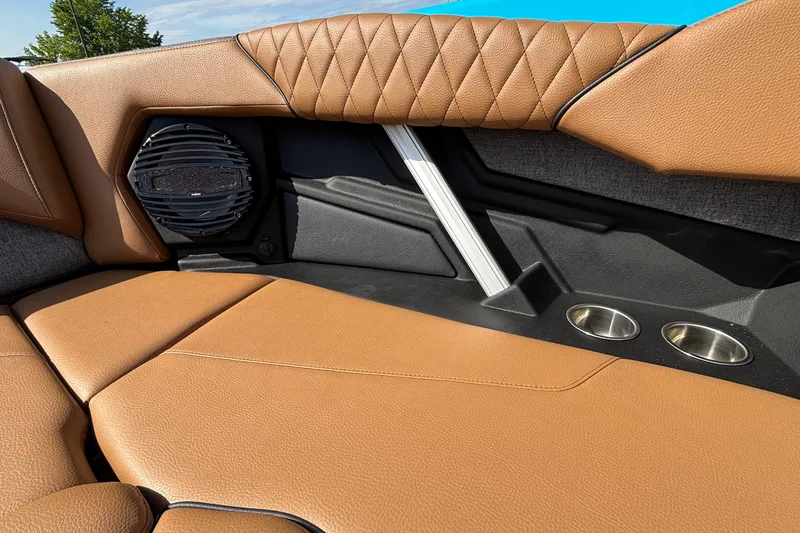Slide: The Image of 2026 Tigé Z3 boat interior with tan leather seats, speaker, and cup holders. - 55
