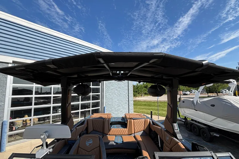 Slide: The Image of 2026 Tigé Z3 boat with sleek design, spacious interior, and modern features under a clear sky. - 56