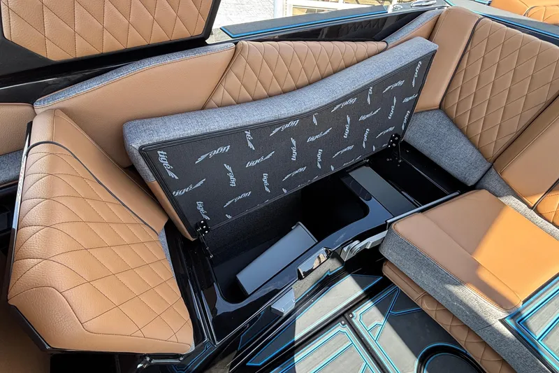 Slide: The Image of 2026 Tigé Z3 boat interior with tan and gray seating, showcasing storage compartment. - 58